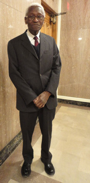 Our friend, John, in a dark suit with a red tie. 