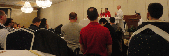 Celebrating Palm Sunday Mass in a hotel ballroom with Archbishop Cepeda. 