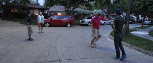 Boys playin' 4-square in our street. 