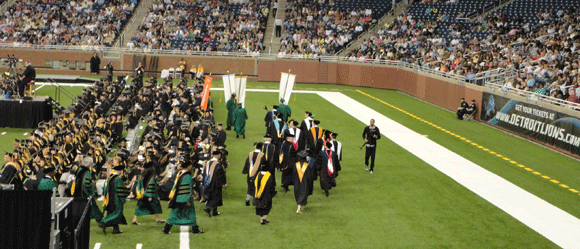 The band was all, "Baaaaah, bah dah dah, bum...bum" and they walked in. Christine has a light blue tassel. We saw her but she had no idea where we were sitting at this point. 
