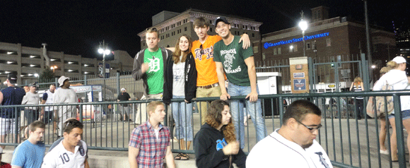 Paul and Nicole and D.J. and Josh watch the game.