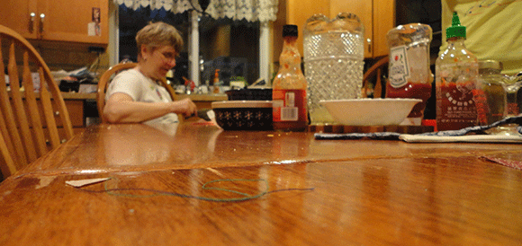 Step four: Get frustrated because it's NEARLY IMPOSSIBLE to turn this sucker inside out. Complain to your mom. Whine at your mom when she takes out the work you have done to "find a better way." Feel guilty and take this picture. Try to remember what you had for dinner that night. Feel guilty that the table isn't cleaner. 