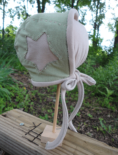 First hat! Pilot-hat-like. Since the gender isn't announced, I went with gender-friendly stars. <3