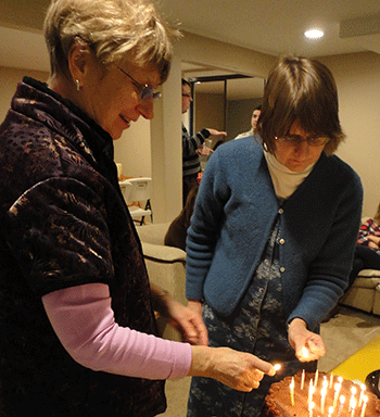 Lighting the birthday cake for the January birthday kids!