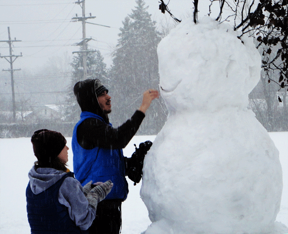 Christine supervises, Josh places the face. 