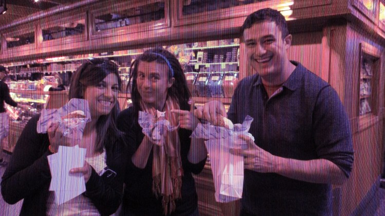 (This is a picture of people and freshly-filled cannoli in a market in Philadelpha). 